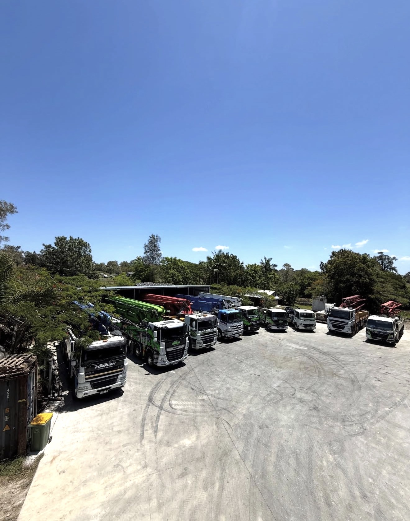 Pumpcon fleet lineup — multiple concrete pump trucks