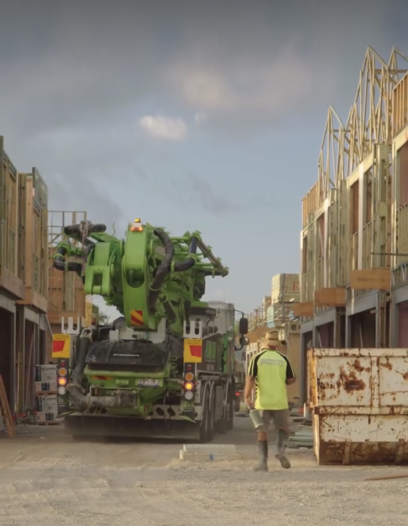 Green Pumpcon boom truck in residential street