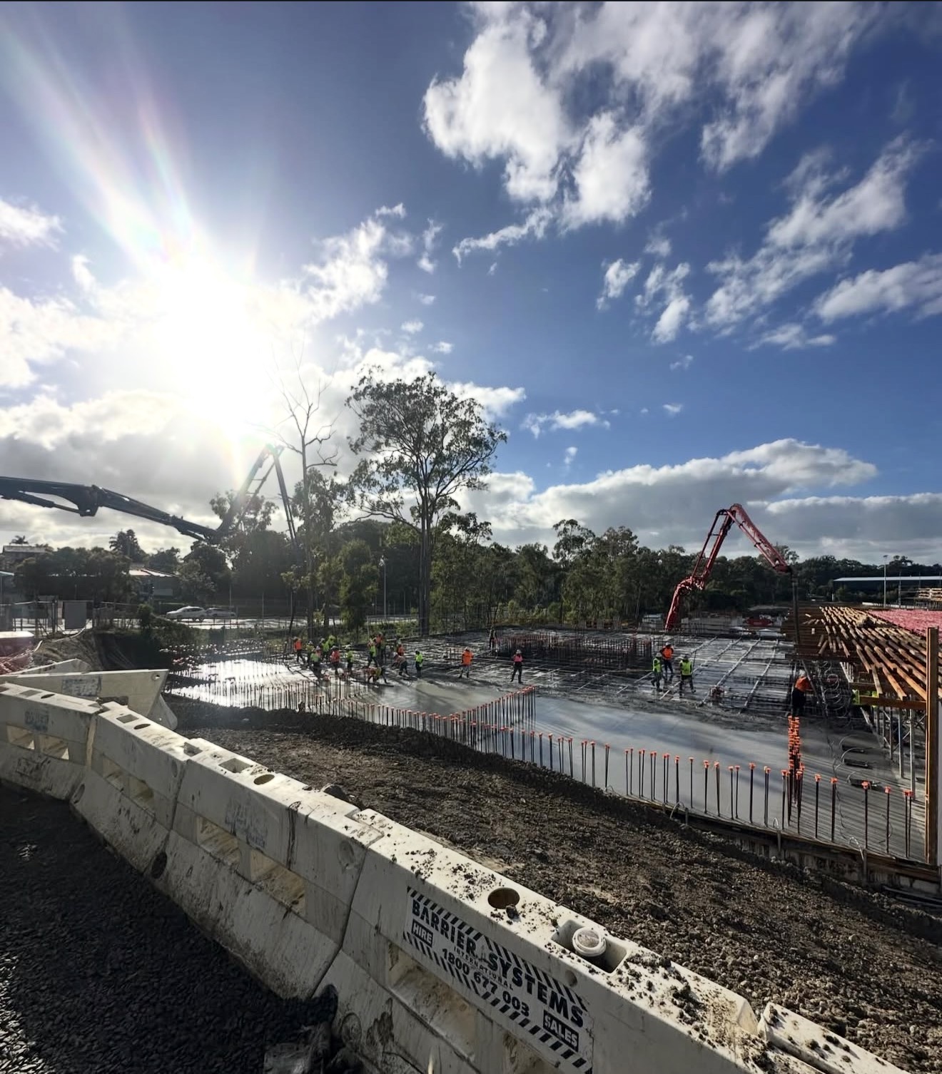 Wide angle concrete pour with sun backdrop